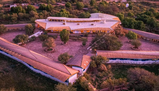 Photographer setting up astrophotography equipment under a starry sky
