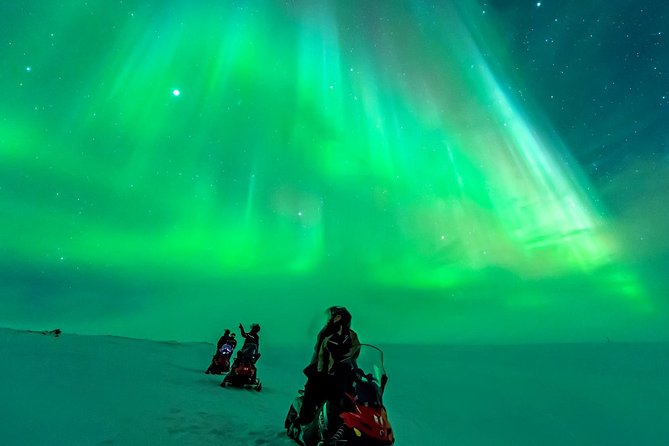 Snowmobiling under the Northern Lights