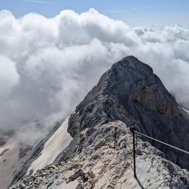 Hikers crossing suspension bridges and enjoying panoramic views in the Julian Alps