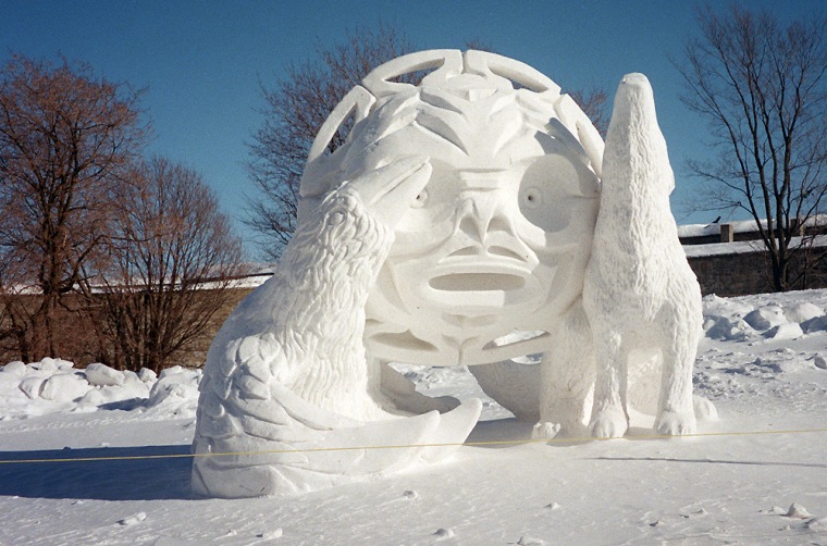 A nighttime view of the illuminated Ice Palace at the Quebec Winter Carnival, highlighting the intricate ice sculptures and the festive atmosphere.