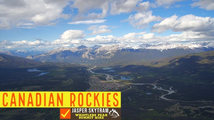 A lone hiker walking along a trail with snow-capped mountains in the background, encapsulating the spirit of solo travel and the stunning scenery of Banff.