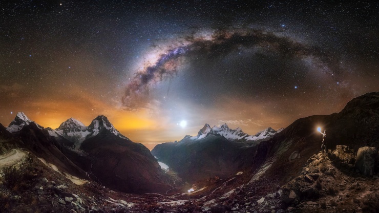 Local Bolivian residents in traditional attire during a festival, with the flooded salt flats in the background