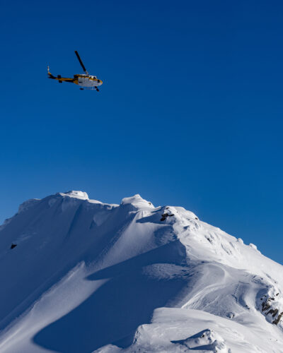 Heli-Skiing - Wide-angle shot of helicopter and mountains