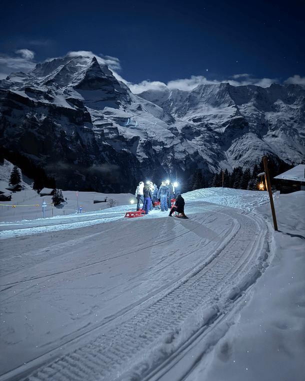A climber on the Via Ferrata, with the village of Mürren below