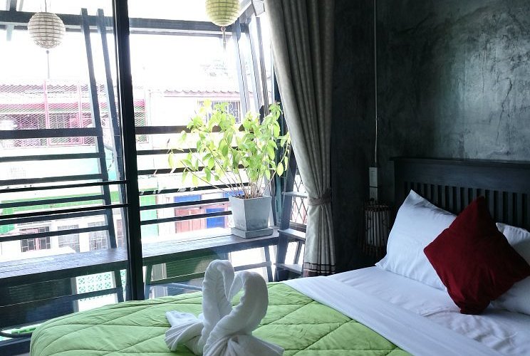 The exterior of The Gecko's Garden hostel, showing its brightly painted walls and welcoming entrance.