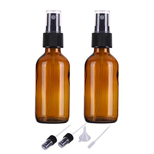 Amber glass spray bottle filled with orange vinegar on a sun-drenched windowsill.