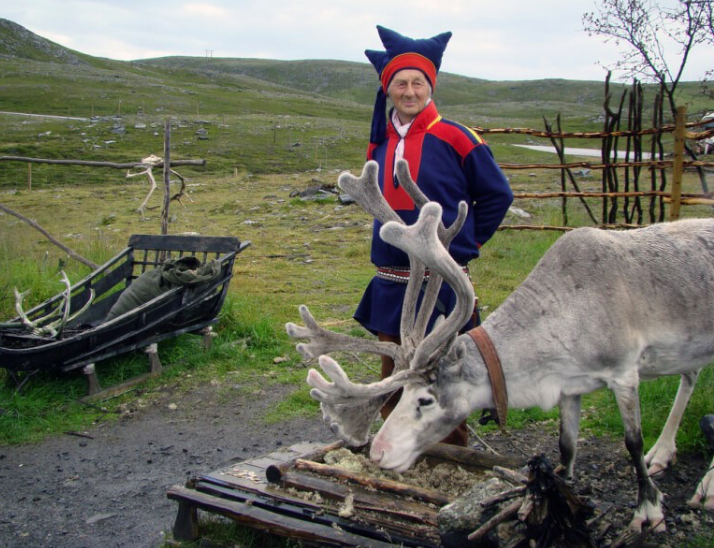 Person putting the finishing touches on a snow igloo