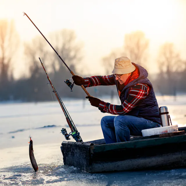 People ice fishing on a frozen lake
