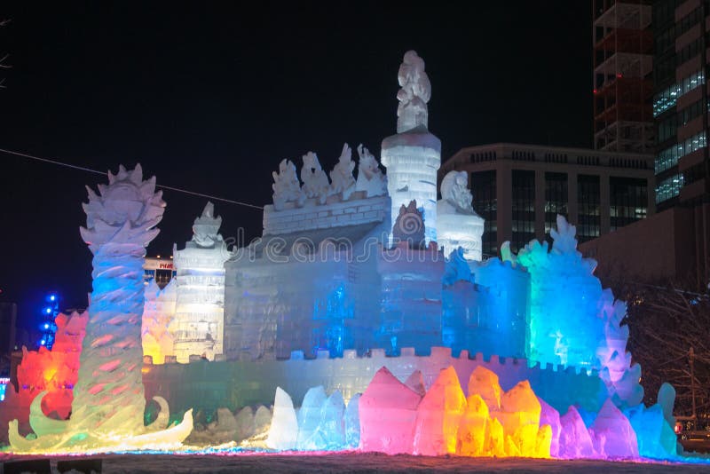 A close-up photo of an intricate ice sculpture at the Sapporo Snow Festival, illuminated at night with a long exposure to capture the vibrant colors and detail.
