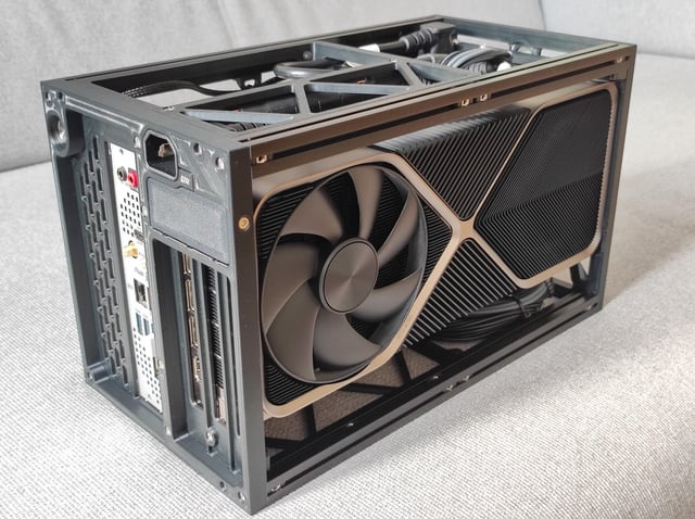 A detail shot highlighting the Fractal Terra’s vents and cable management channels. Show the silver accents against the black finish.