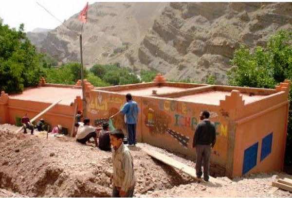 Elias Thorne sitting with a Berber family in Imlil, sharing tea and conversation