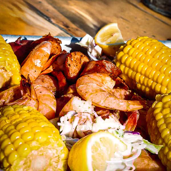 A sunset view of the Savannah River, with a riverboat cruising along the water, silhouetted against the colorful sky, capturing the scenic beauty and serene atmosphere of a riverboat cruise.