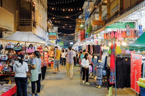 Wide shots of the camp blending seamlessly with the lush jungle landscape, capturing the golden light at dawn