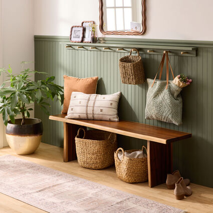A warm entryway, decorated with pumpkins and autumn colors, inviting a sense of the season.