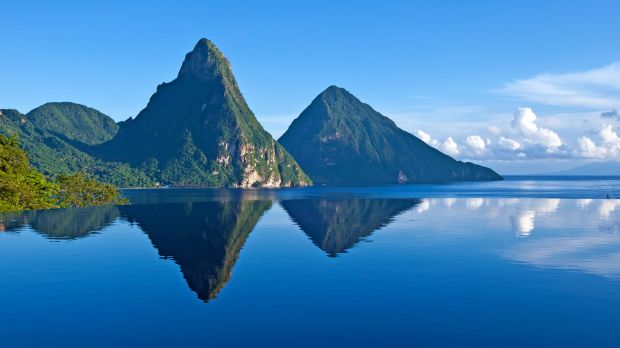 Emily and Ben stargazing from their private infinity pool in the Celestial Suite, clearly showing the Pitons in the background