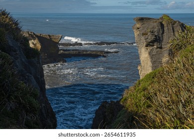 Pancake Rocks formations showing the layered rock and the spray of water from a blowhole