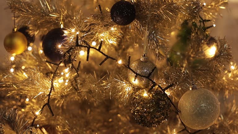 A dried orange garland draped over a rustic wooden mantelpiece, alongside an evergreen wreath and other festive decorations.