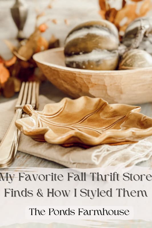 A shelf display of thrift store finds, featuring vintage pitchers, decorative plates, and rustic accents, adding character and charm to the farmhouse kitchen.