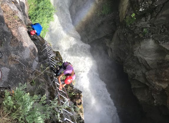 ice climbing on a frozen waterfall, swiss alps