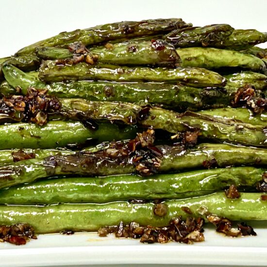 A short video clip showing the process of drizzling honey over vegetables before roasting.