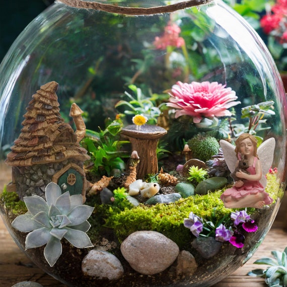 A tiny pond created with blue-colored glass beads, surrounded by pebbles and miniature plants, adding a touch of sparkle to the fairy garden.