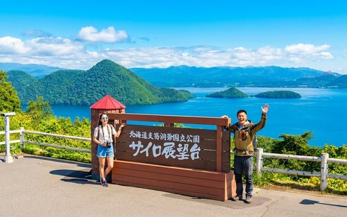 Images of couples biking side-by-side with Mt. Yotei in the background, close-ups of the fat bike tires gripping the snow, shots of steaming breath in the cold air