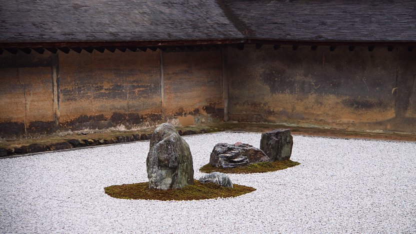 A serene Zen garden with meticulously raked gravel and carefully placed rocks