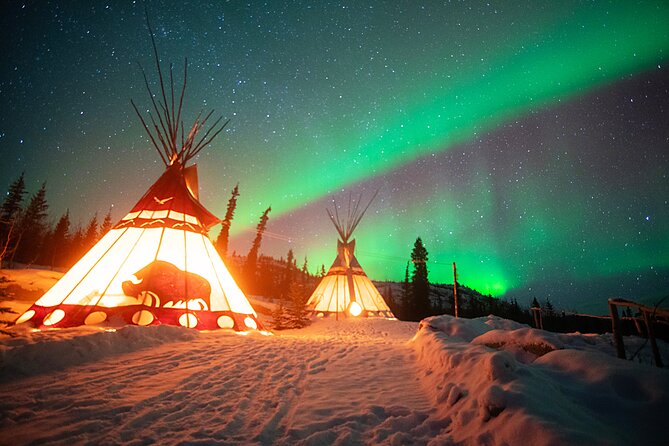 An aurora dome, lit from within, glows in the snowy landscape under a starry night sky.