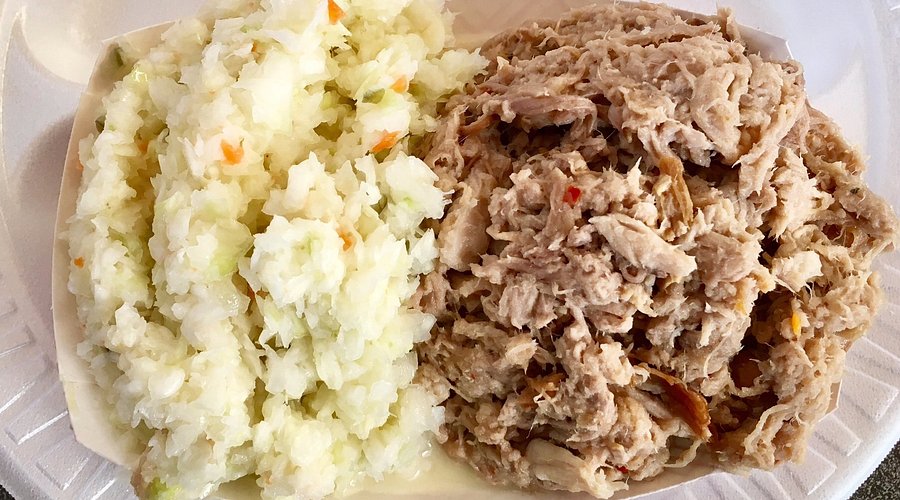 Close-up of a Lilac-breasted Roller perched on a branch in the Okavango Delta, with dappled sunlight filtering through the trees