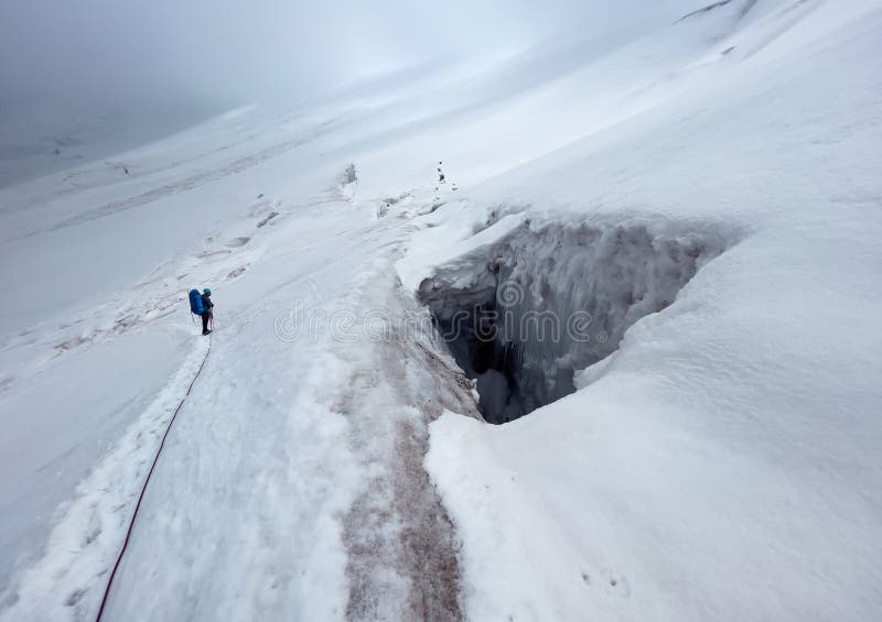 A skijorer being pulled across Khuvsgul Lake by a Mongolian horse, with traditional yurts dotting the snow-covered landscape in the background. Capture the golden light of sunset reflecting on the frozen lake and the horse's breath.