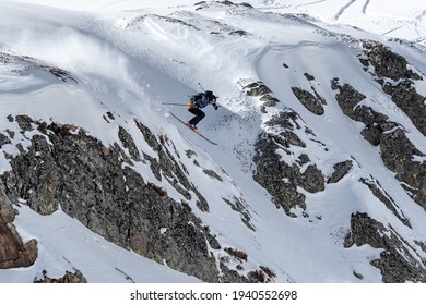 A panorama shot of Sant Climent de Taüll church, framed by snow-covered fields and mountains, captured on a clear winter day. The image emphasizes the church's architectural beauty against the backdrop of the stunning winter landscape.