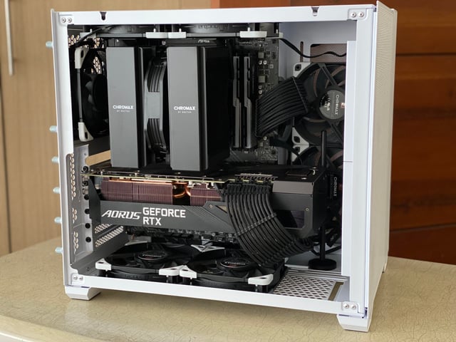 Assembled PC rig setup featuring the retro-inspired gaming PC, SteelSeries Aerox 5 Wireless mouse, Keychron Q1 keyboard with retro keycaps, and ASUS VP249QGR monitor, all arranged in a cozy gaming environment.