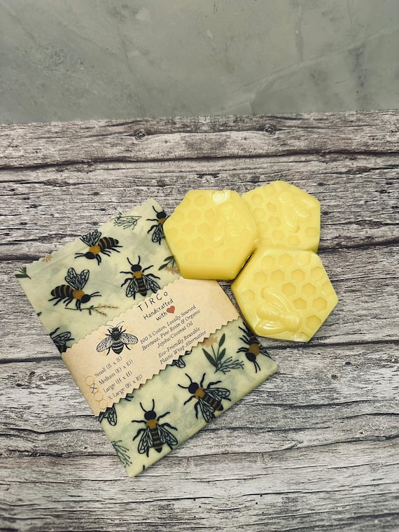 Applying melted beeswax mixture to a fabric square with a paintbrush