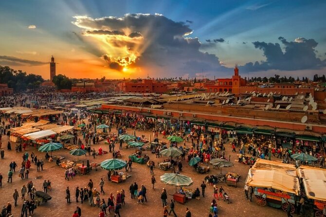 A bustling marketplace scene in Marrakech, with vendors selling colorful spices, textiles, and pottery. This represents the vibrant and chaotic atmosphere of the souks and the sensory overload experienced upon arrival.