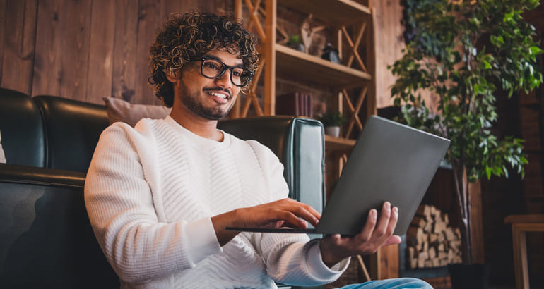 A diverse team of people working together on laptops, symbolizing collaboration and innovation