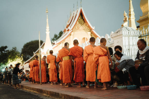 Monks collecting alms during the Tak Bat ceremony in Luang Prabang, capturing the essence of Lao spirituality.