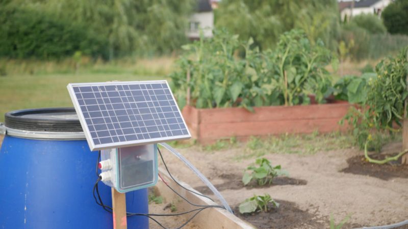 Solar panel setup with charge controller and battery, powering a submersible pump for the rainwater harvesting system.