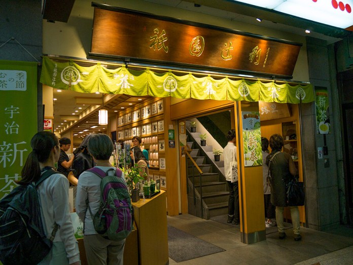A close-up shot of a matcha parfait, highlighting the layers of mochi, red bean paste, and matcha ice cream in a soft, ethereal light