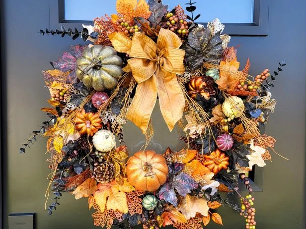 A homemade autumn wreath made with various fall-themed decorations