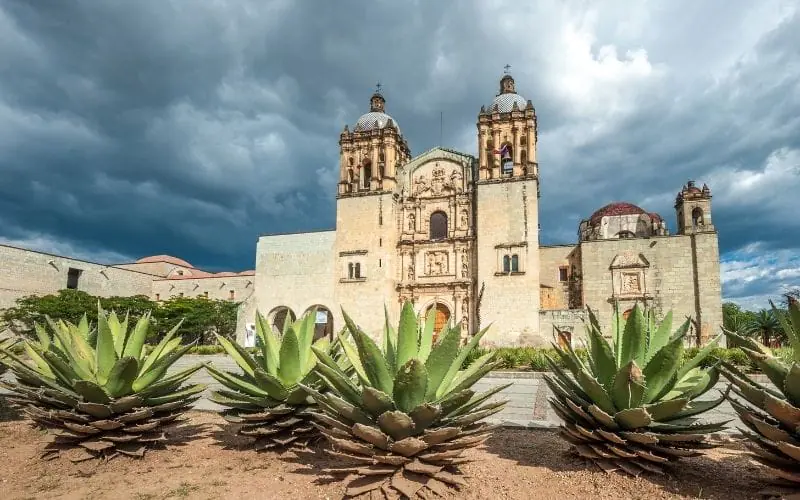 A vibrant Oaxacan market scene with colorful produce and people