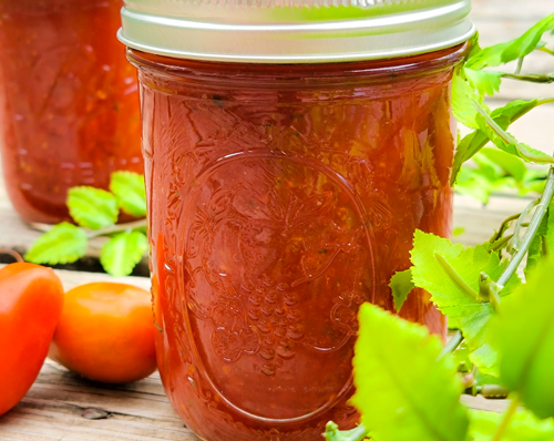Steps involved in making tomato sauce, from chopping vegetables to simmering the sauce