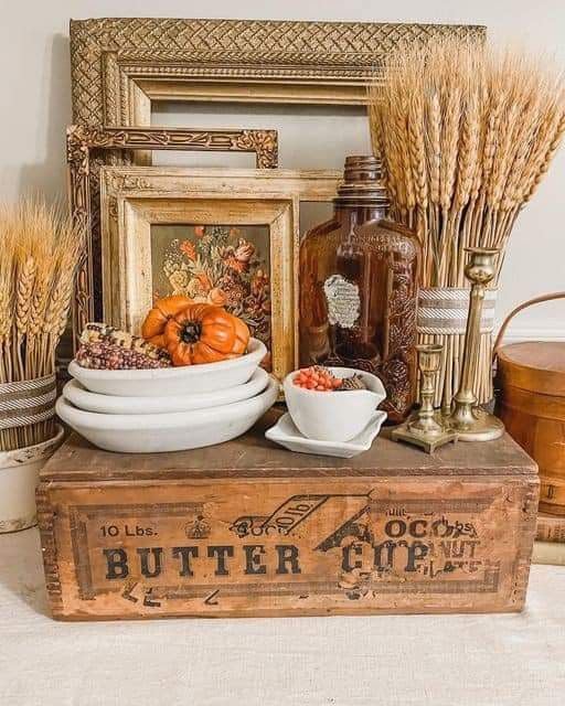 A vignette showcasing fall decor on a wooden surface