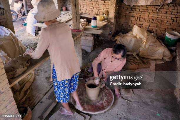 Hands shaping clay on a potter's wheel