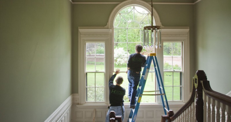 New energy-efficient windows being installed in a farmhouse, illustrating window upgrades.