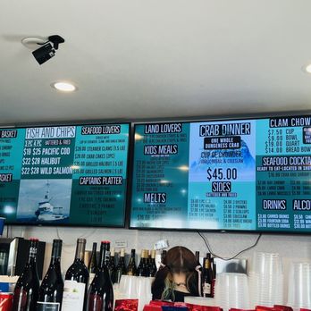 Tourists at Cannon Beach with Haystack Rock