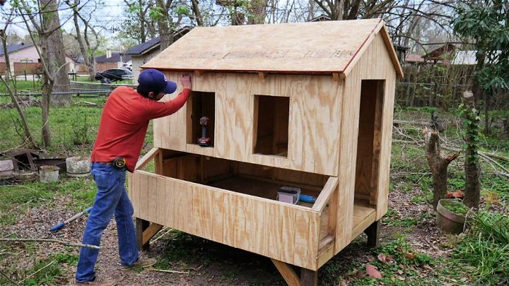An illustration of a chicken coop from a bird's eye view, complete with nesting boxes, feed troughs and water dishes.