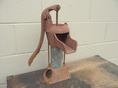 An old, rusty hand pump