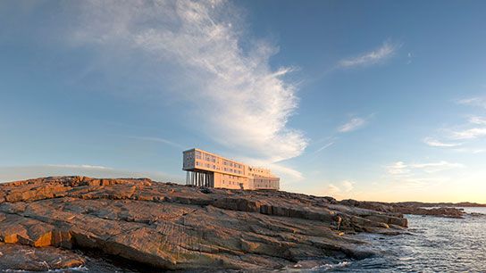 Anya and local artisans joyfully showcasing vibrantly colored quilts.