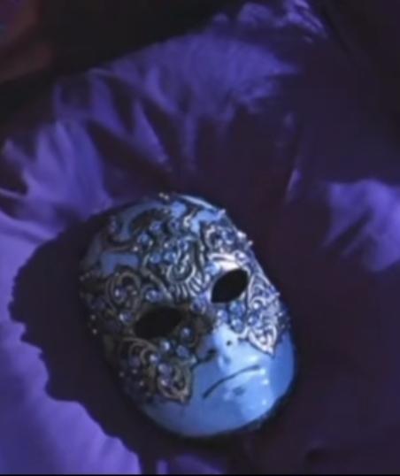 A still from Eyes Wide Shut showing the masked figures bowing, highlighting the power dynamics and ritualistic aspects of the elite gathering.