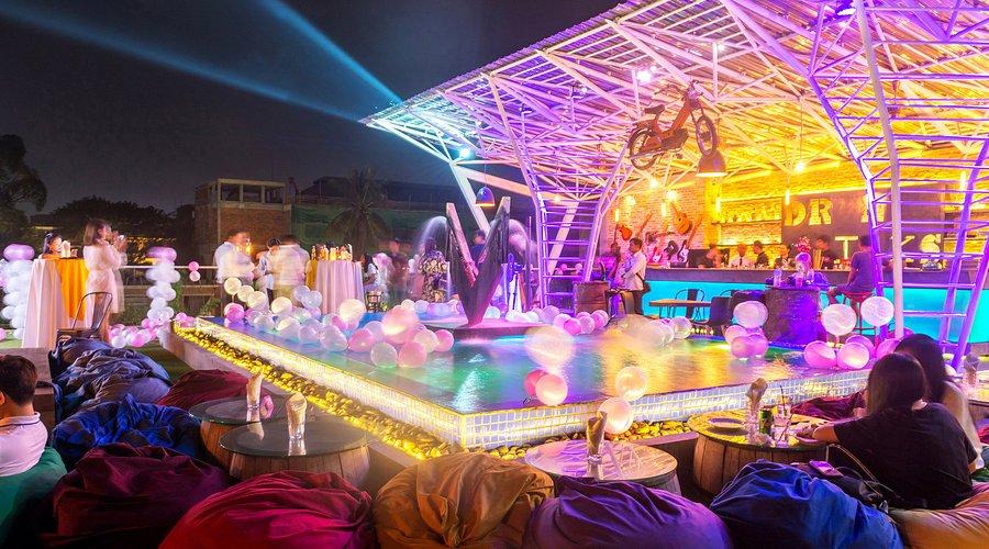 Laptop and coffee on a table at a coworking space, showcasing the warm lighting and focused atmosphere